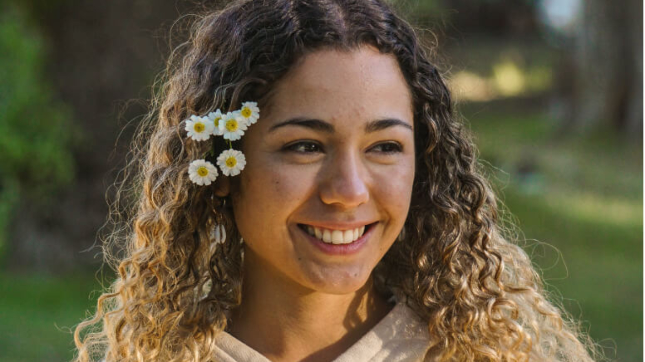 Teen with straight teeth and flowers in her hair